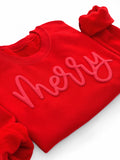 Red sweatshirt with 'merry' text on a white background